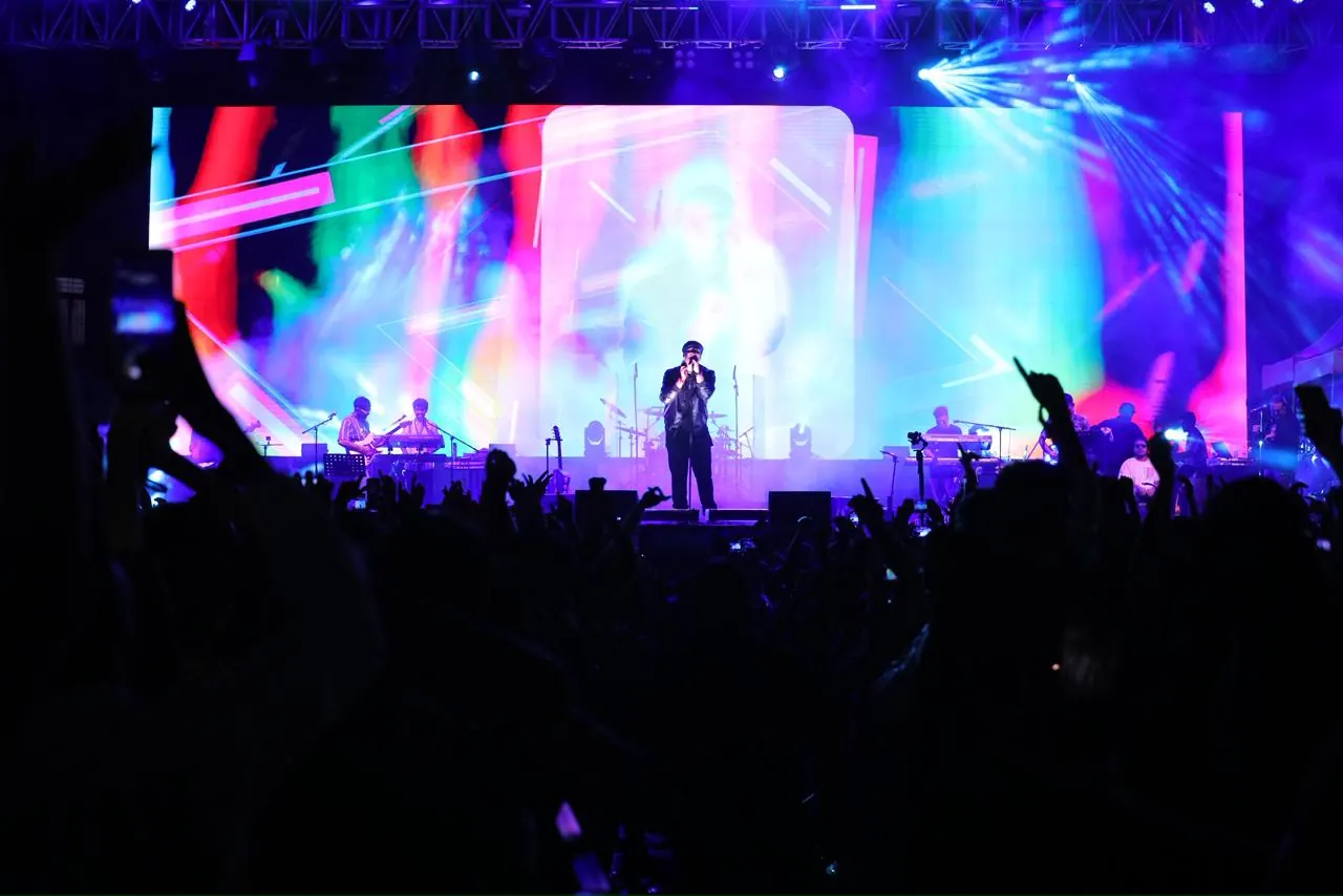 Live performance on stage with lights at an entertainment event by Show Squad Events